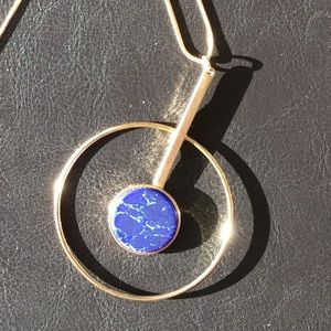 Long blue and gold tone circle pendant